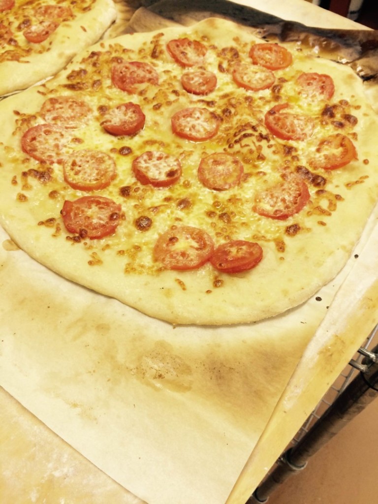 alt=roman pizza with tomatoes and mozzarella cheese