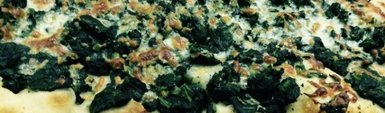alt=pizza with spinach and mozzarella cheese