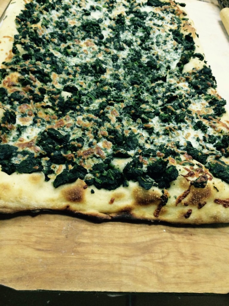 alt=pizza with spinach and mozzarella cheese